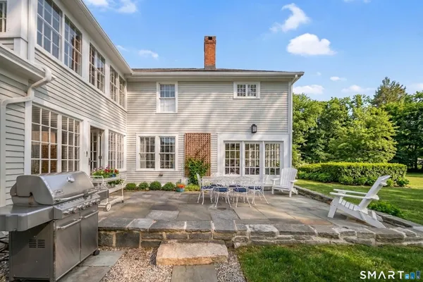 a front view of a house with a yard and outdoor seating