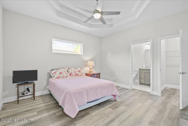 a bedroom with a bed and a chandelier