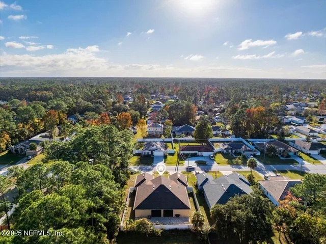 an aerial view of residential building with trees