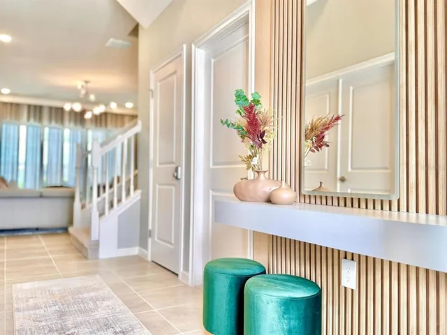 a living room with furniture and a potted plant