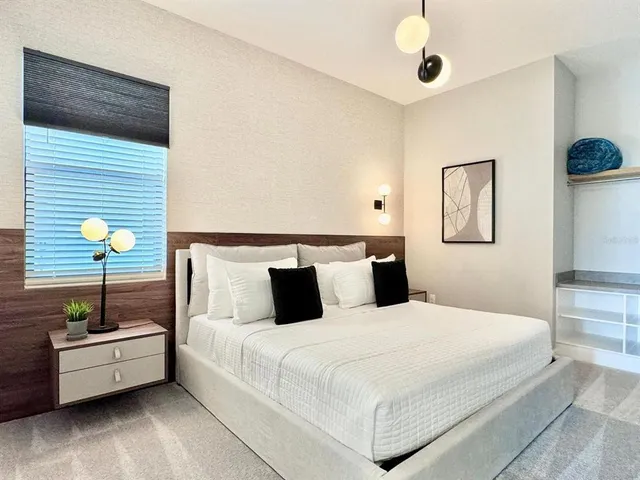 a bed room with a bed and a potted plant