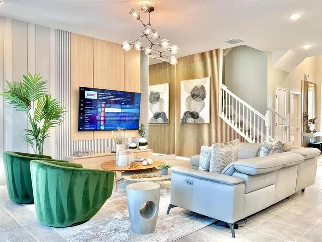 a living room with furniture and a chandelier