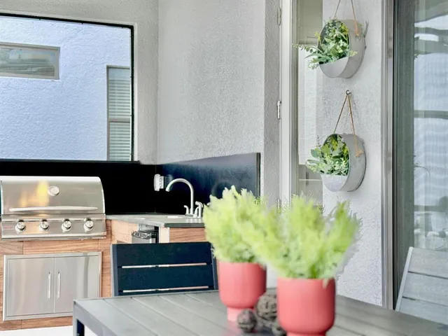 a kitchen with a stove a refrigerator and a dining table