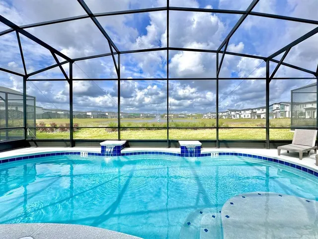 a view of a swimming pool with a back yard