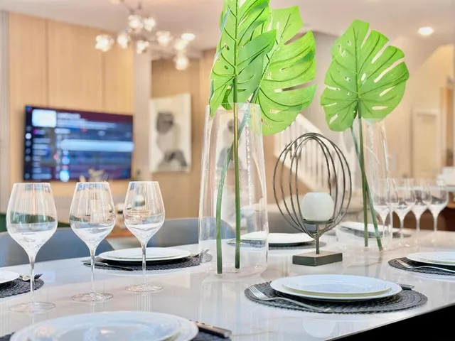 a vase of flowers sitting on a table with a fireplace