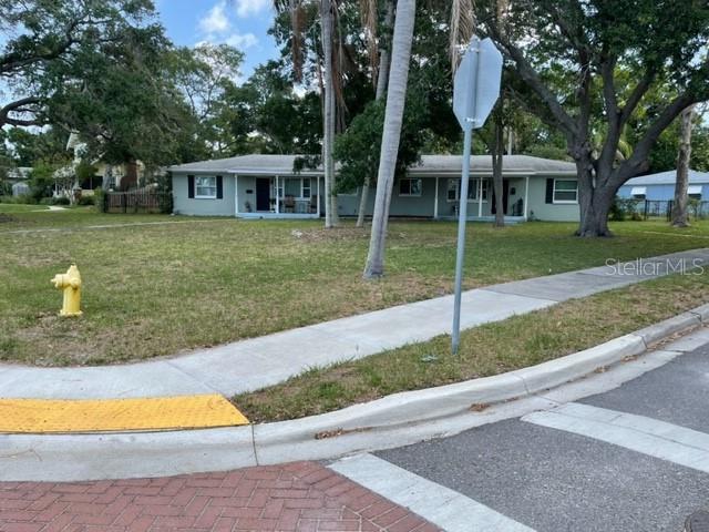 709 Indian Rocks Road Belleair, FL 33756 - Photo 12 of 19 a front view of a house with a yard and garage