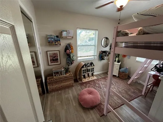 a view of a livingroom with furniture a flat screen tv and wooden floor