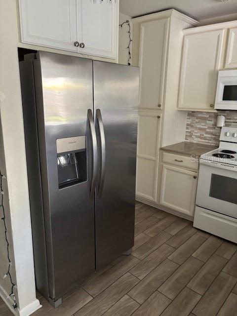 709 Indian Rocks Road Belleair, FL 33756 - Photo 7 of 19 a metallic refrigerator freezer sitting in a kitchen