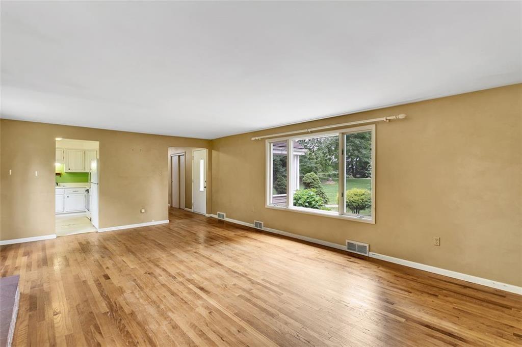217 Center Church Road Canonsburg, PA 15317 - Photo 4 of 26 a view of an empty room with wooden floor and a window