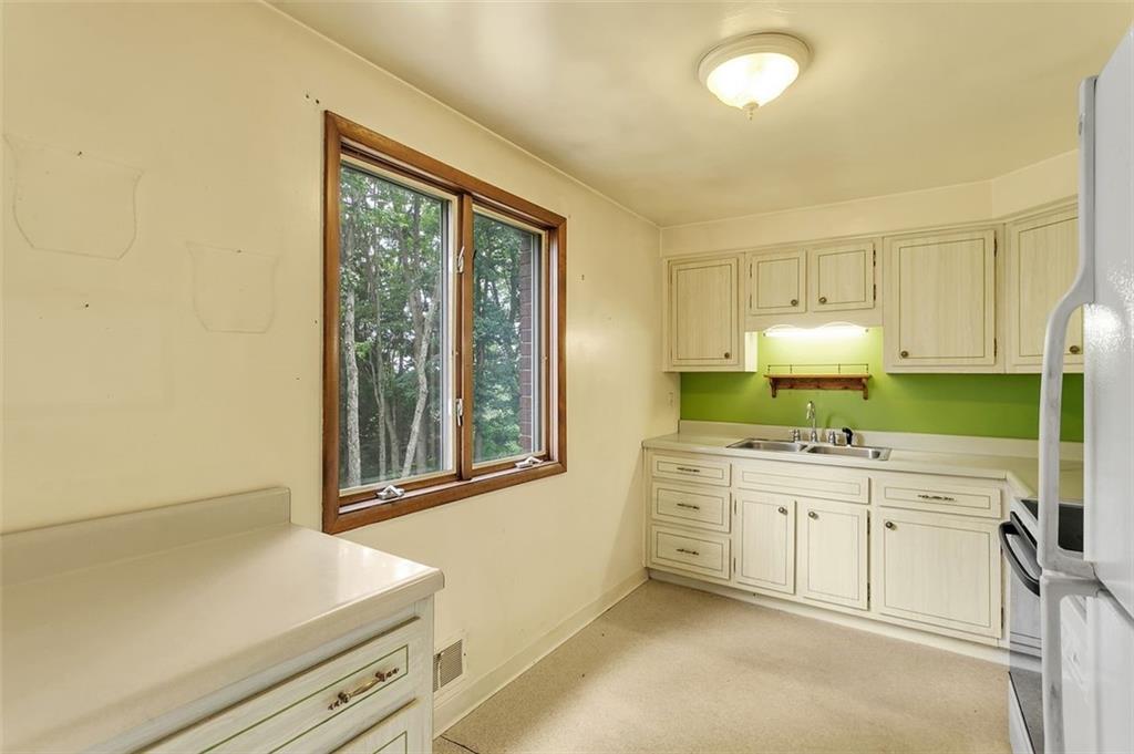 217 Center Church Road Canonsburg, PA 15317 - Photo 7 of 26 a kitchen that has a sink a stove and cabinets