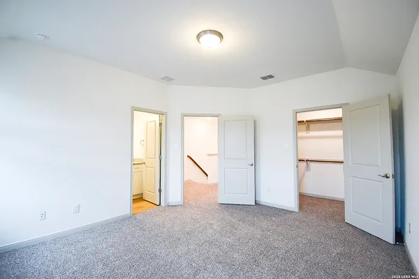 a view of walk in closet with empty racks