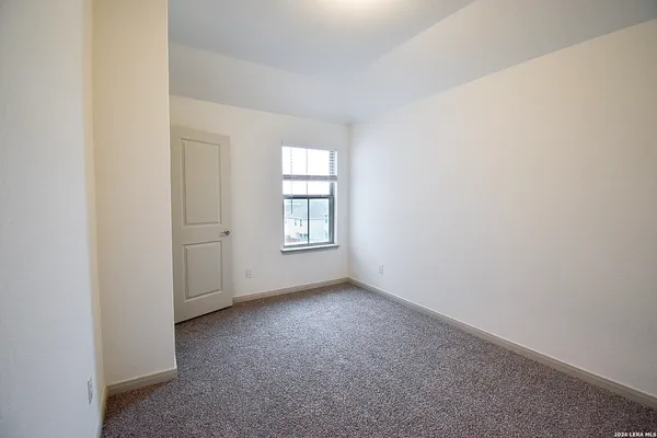 an empty room with windows and closet
