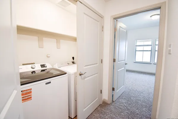 an empty room with closet and windows
