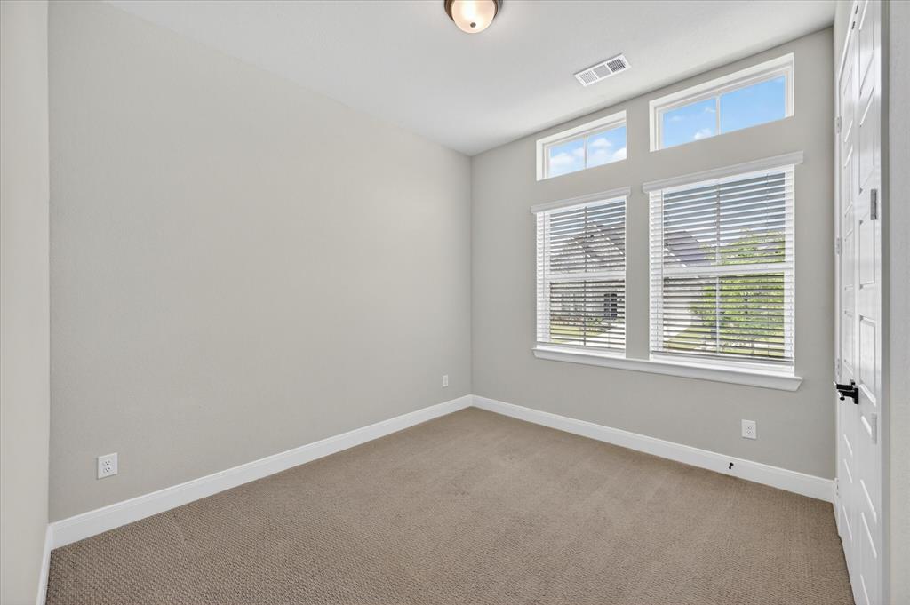 2237 Pika Road Northlake, TX 76247 - Photo 23 of 37 Neutral-toned room featuring a multi-paneled door, recessed ceiling light, and light brown carpet flooring