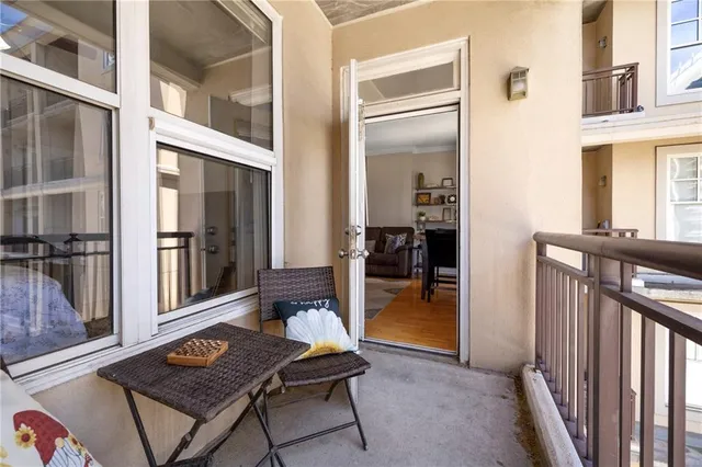 a view of a hallway and a livingroom with furniture