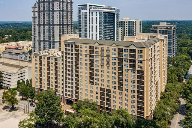 a front view of a building with windows and trees