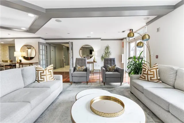 a living room with furniture and a chandelier