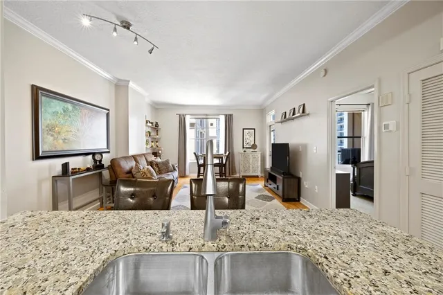 a living room with granite countertop furniture and flat screen tv