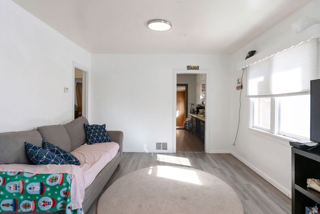 654 North 100 East Logan, UT 84321 - Photo 6 of 41 Living area featuring light wood-style floors and baseboards