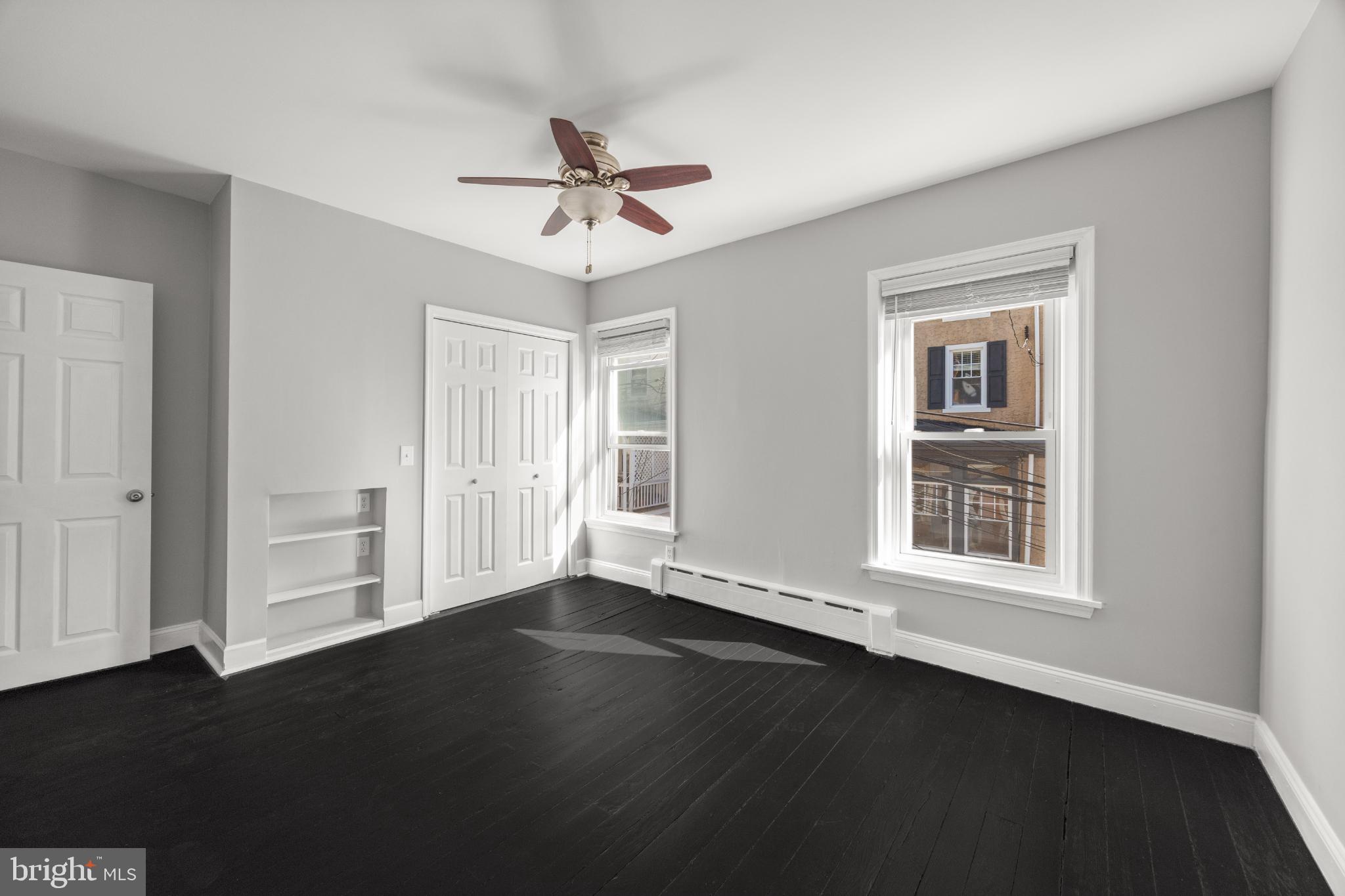 348 Carson Street Philadelphia, PA 19128 - Photo 12 of 27 a view of an empty room with wooden floor and a window