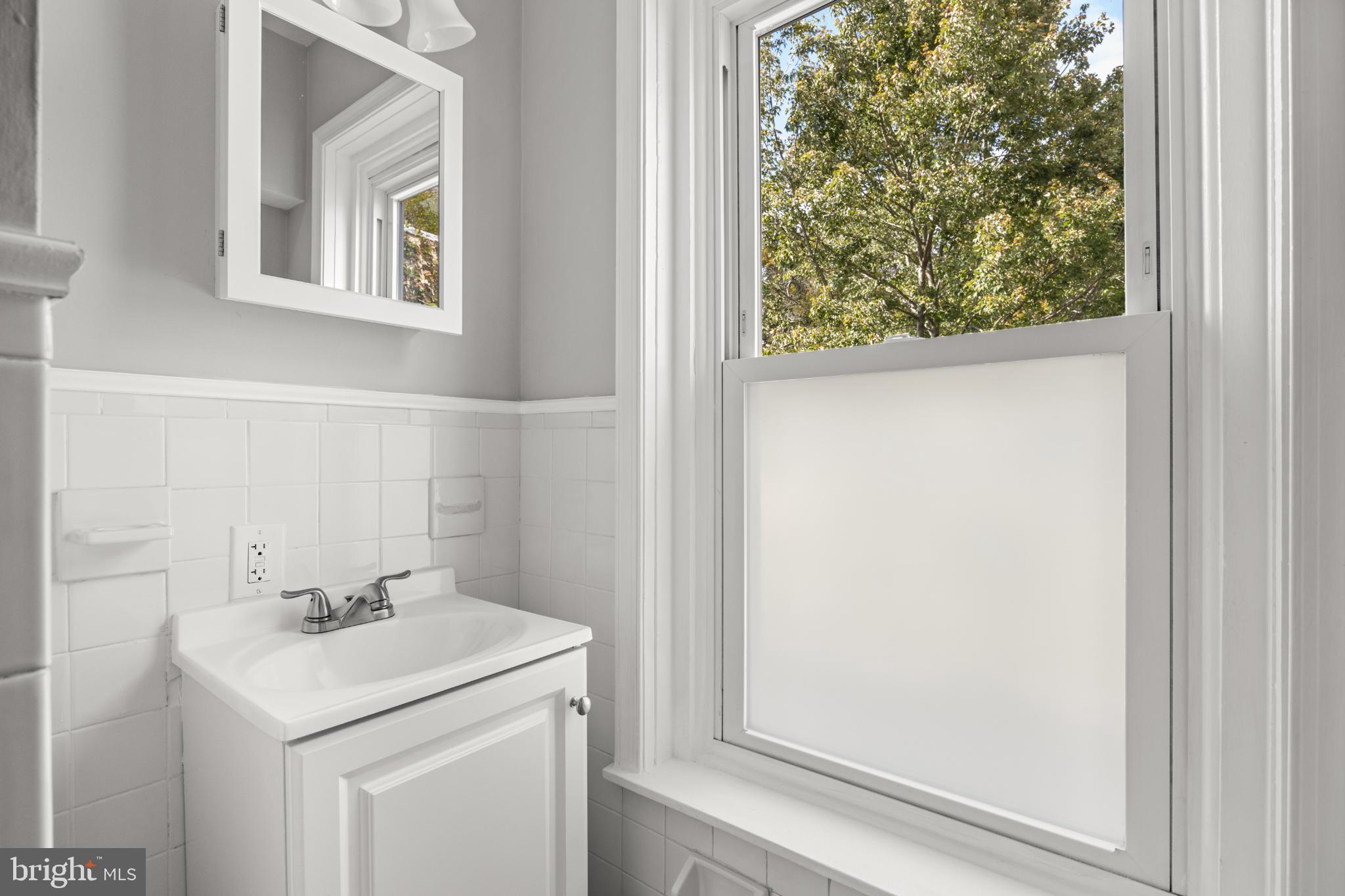348 Carson Street Philadelphia, PA 19128 - Photo 16 of 27 a bathroom with a sink and a mirror