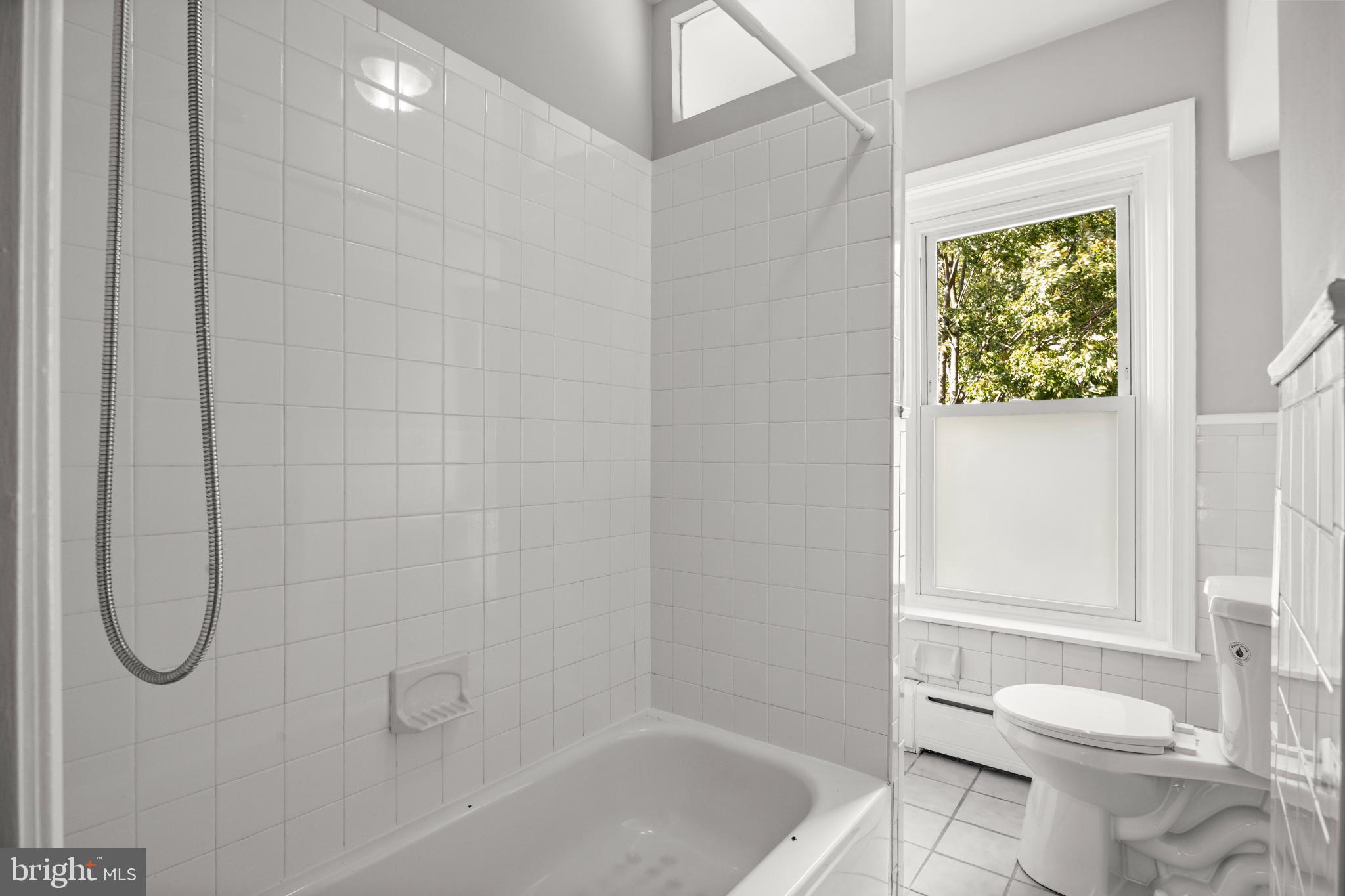 348 Carson Street Philadelphia, PA 19128 - Photo 17 of 27 a bathroom with a granite countertop toilet and a bathtub