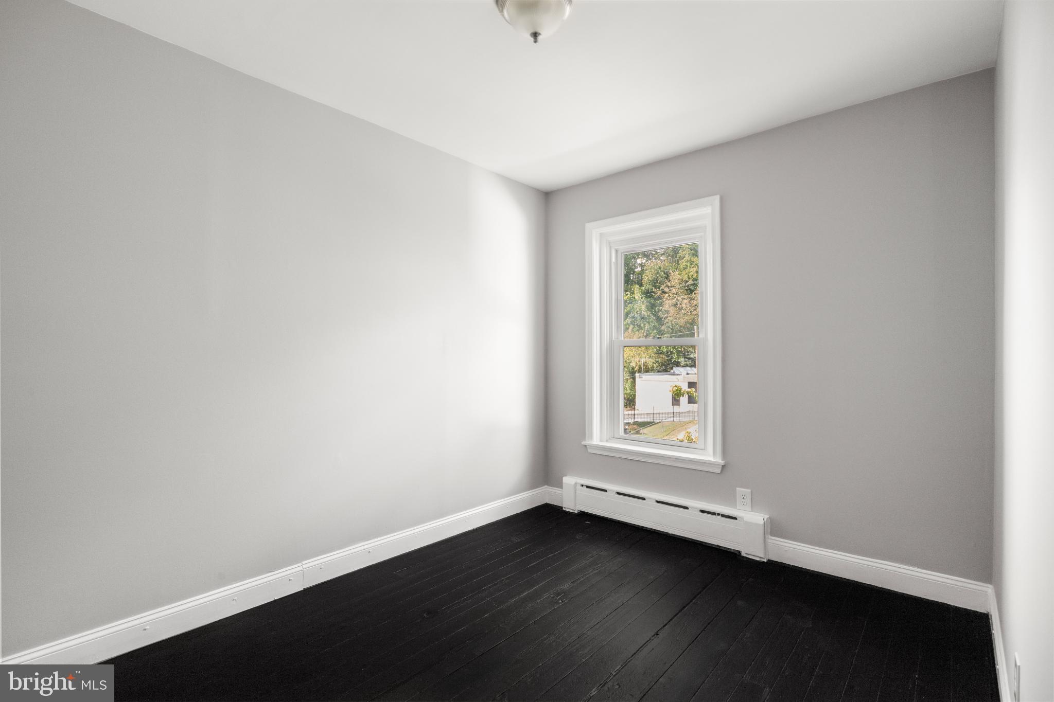 348 Carson Street Philadelphia, PA 19128 - Photo 19 of 27 an empty room with wooden floor and window
