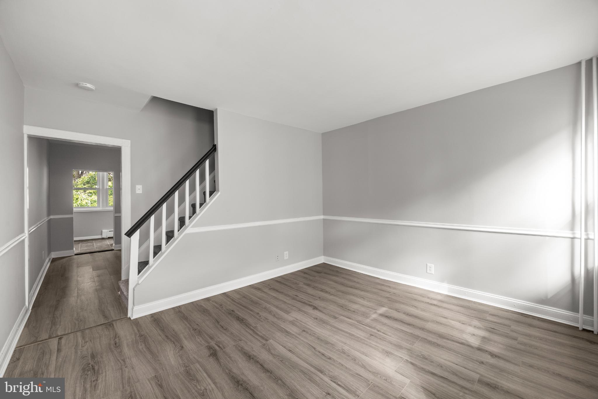 348 Carson Street Philadelphia, PA 19128 - Photo 2 of 27 a view of an empty room with wooden floor and stairs