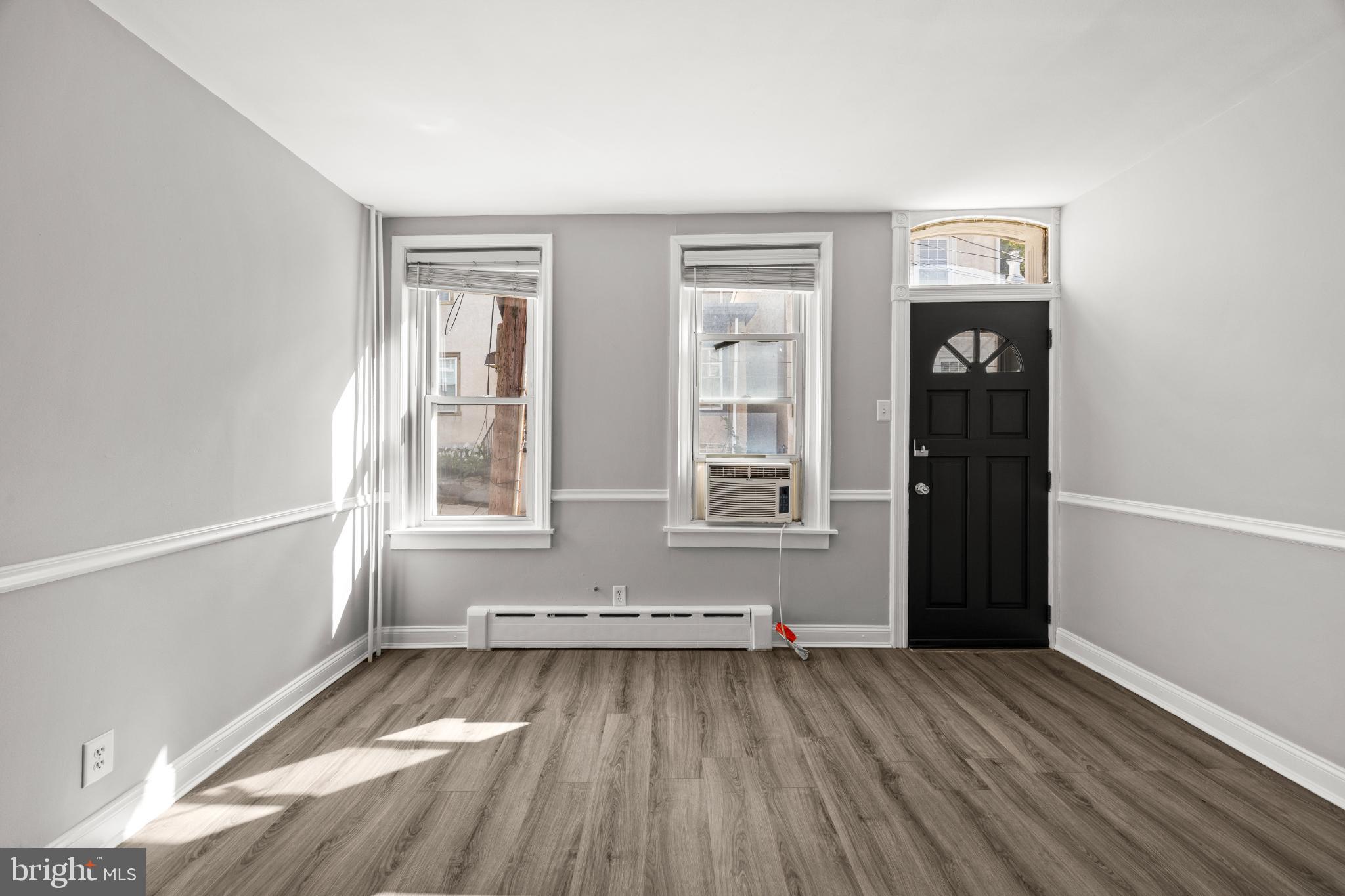 348 Carson Street Philadelphia, PA 19128 - Photo 4 of 27 a view of an empty room with wooden floor and a window