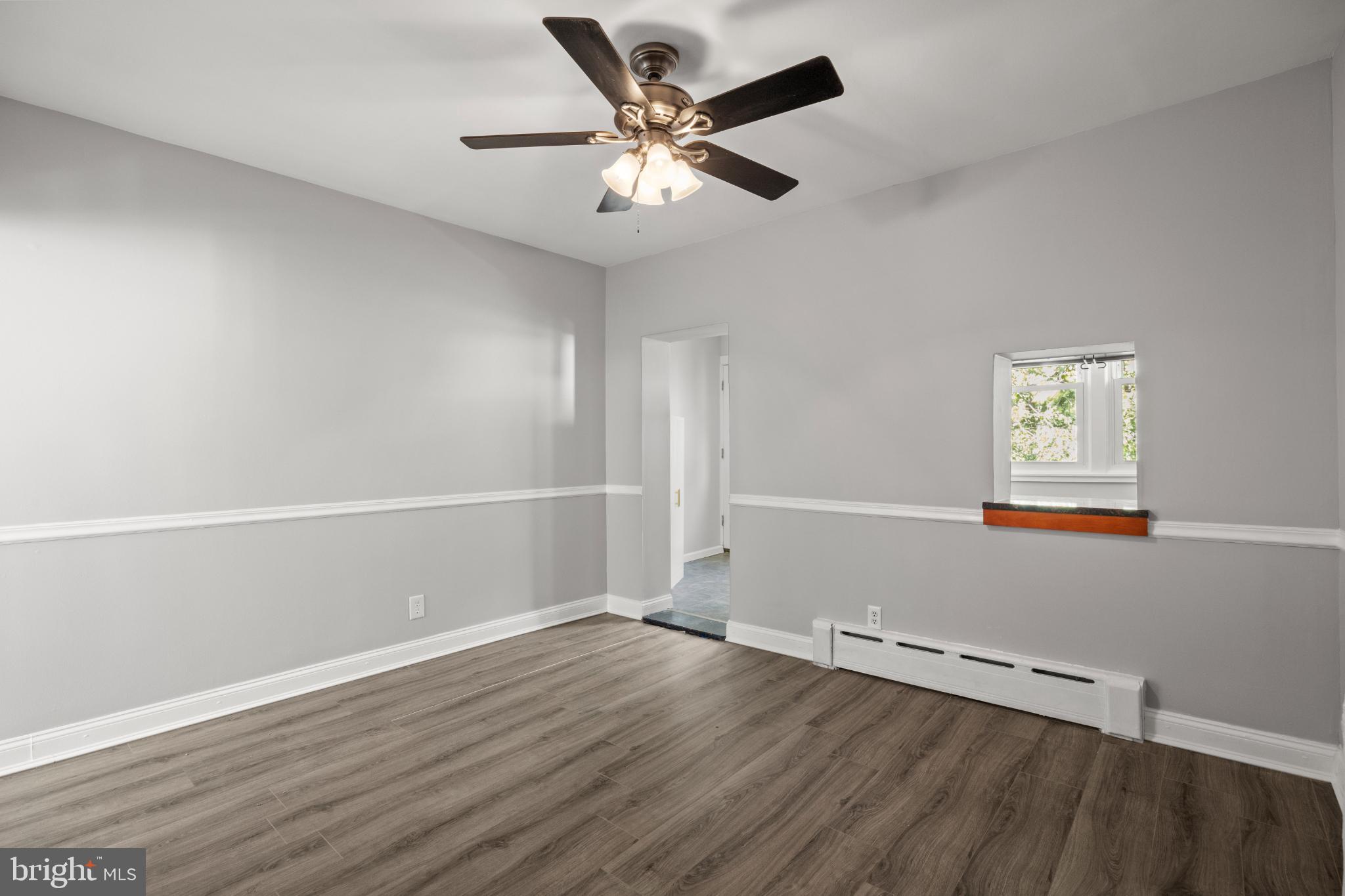 348 Carson Street Philadelphia, PA 19128 - Photo 7 of 27 an empty room with wooden floor and windows
