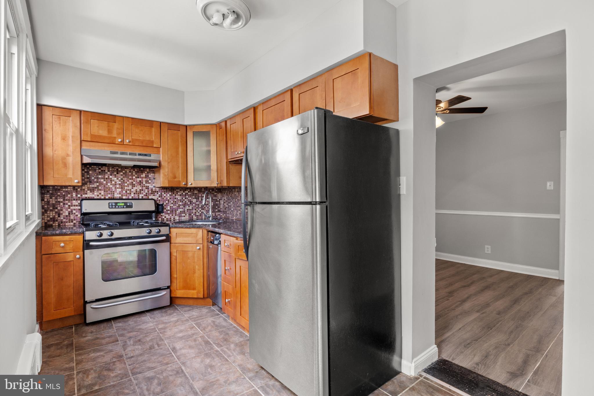 348 Carson Street Philadelphia, PA 19128 - Photo 8 of 27 a kitchen with stainless steel appliances granite countertop a refrigerator and a stove