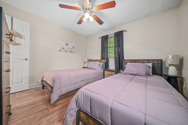 a bedroom with two beds and a chandelier