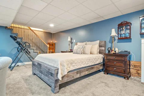 a bedroom with a bed and a chandelier