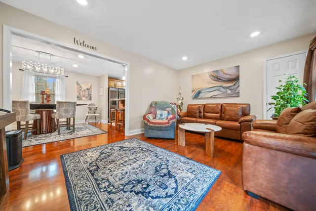a living room with furniture and a wooden floor