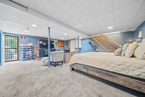 a bed room with a bed and a large window