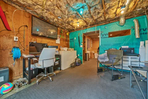 a view of a chairs and tables in the back yard of the house