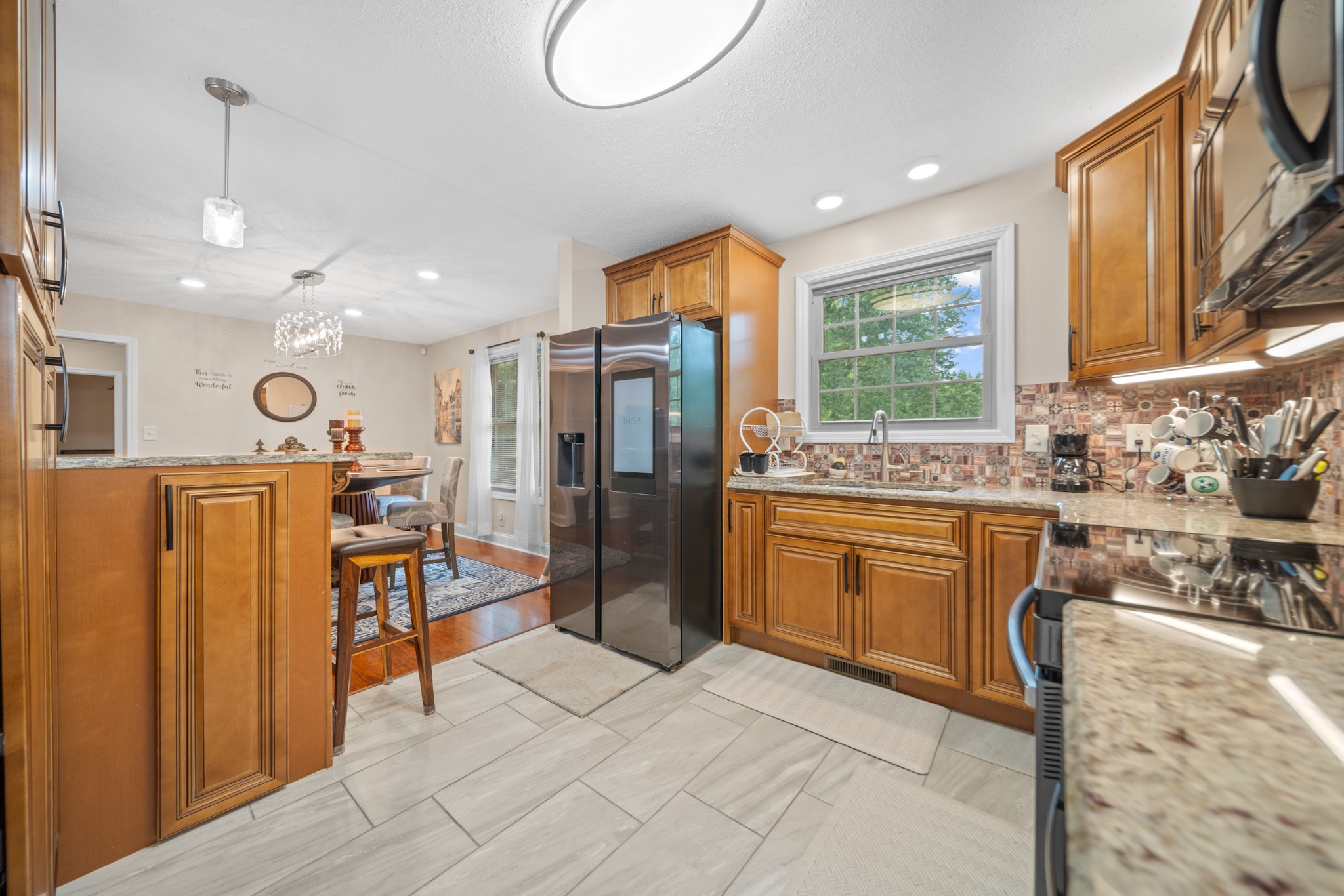 739 Pollard Road Clarksville, TN 37042 - Photo 8 of 41 a kitchen with stainless steel appliances granite countertop a refrigerator a oven a sink dishwasher and white cabinets with wooden floor