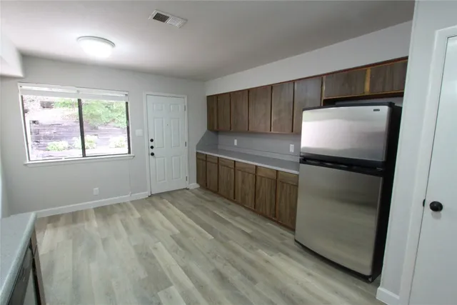 a kitchen with stainless steel appliances a refrigerator and a stove