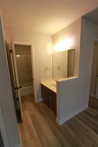 a bathroom with a sink a mirror and a shower