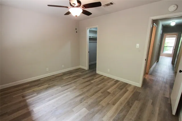 wooden floor in an empty room with a mirror