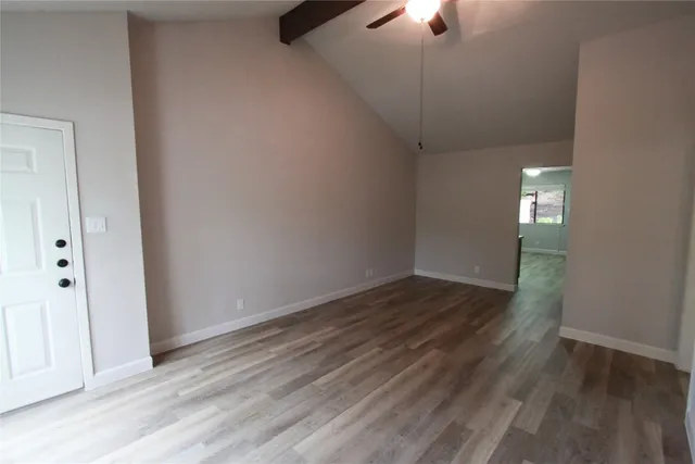 wooden floor in an empty room with a window