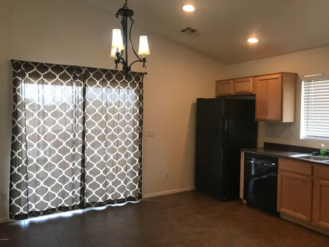 a kitchen with a refrigerator and a sink