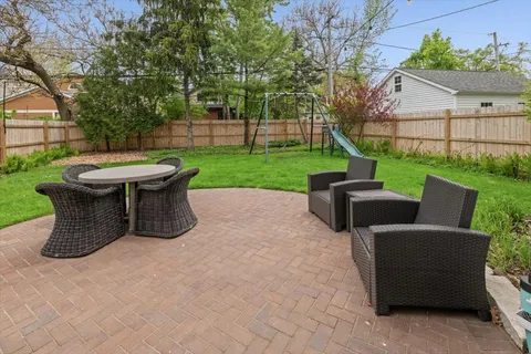 a view of a garden with furniture