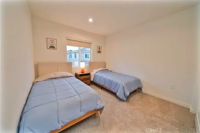 a bedroom with two beds and window