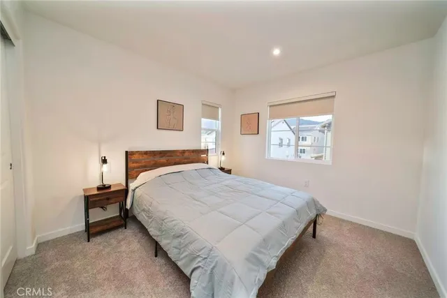 a bedroom with a bed and a night stand