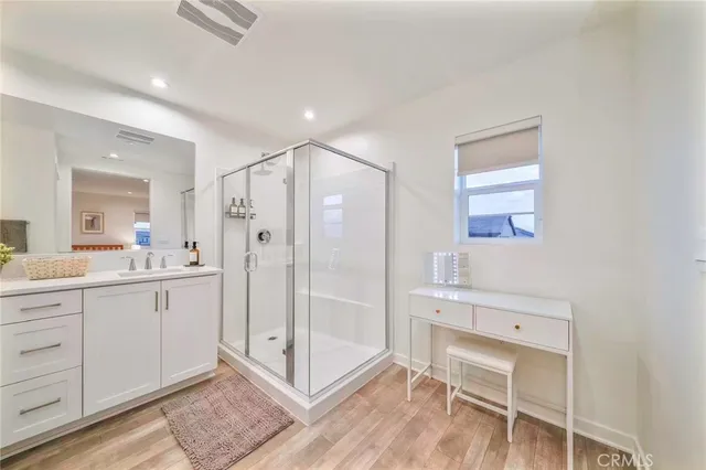 a bathroom with a shower a sink and a mirror