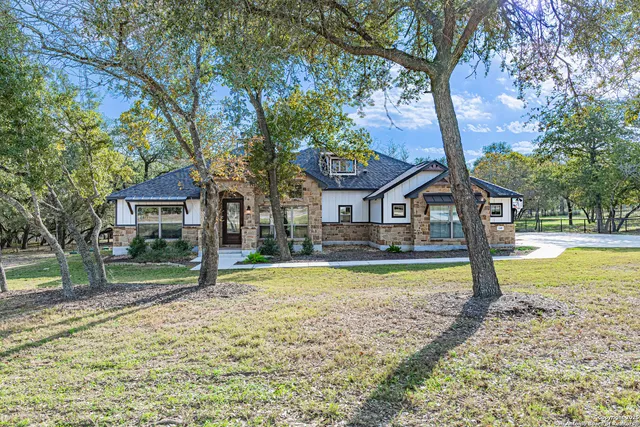 a front view of a house with swimming pool having outdoor seating