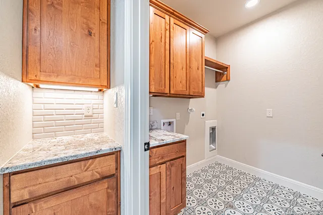 a bathroom with a granite countertop sink and a window