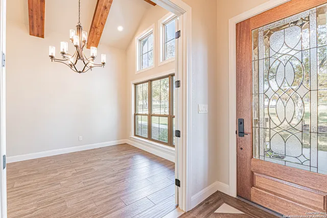 a view of an entryway with wooden floor