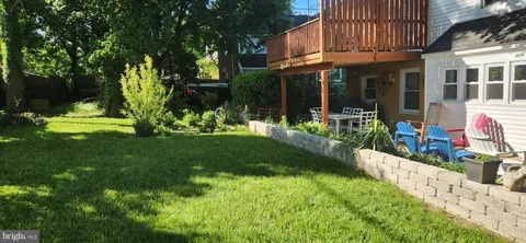 a front view of a house with a yard table and chairs